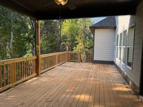 a view of a balcony with wooden floor