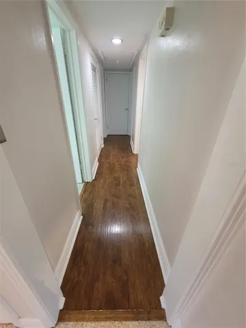 a view of a hallway with wooden floor