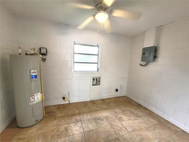 a view of empty room with windows and ceiling fan