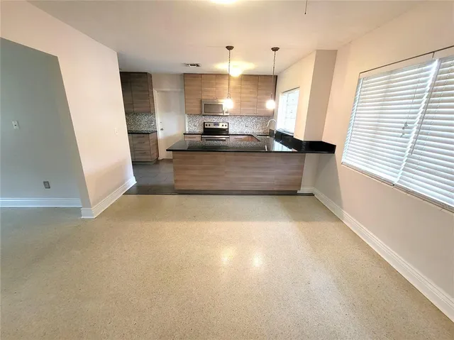 a view of kitchen with stove and window