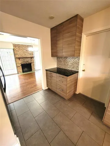 a view of an empty room with a fireplace and a window