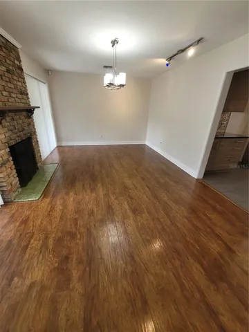 wooden floor in an empty room with a fireplace