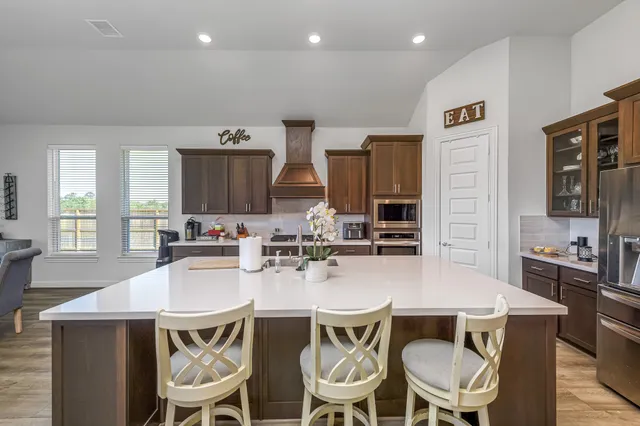 a kitchen with a dining table chairs and microwave