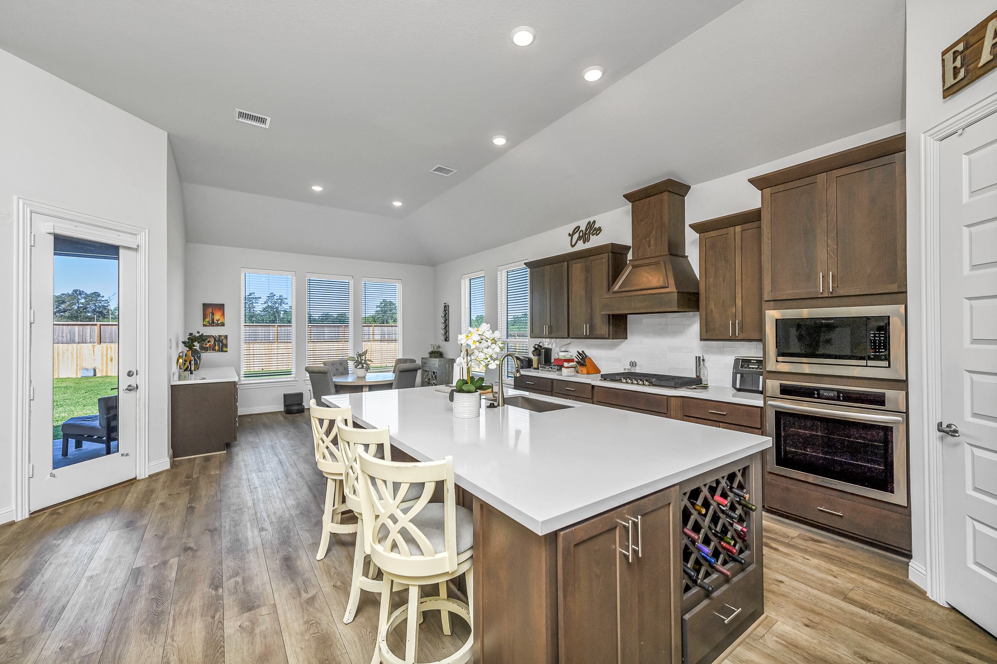 41015 Kimber Lane Magnolia, TX 77354 - Photo 2 of 44 a kitchen with stainless steel appliances a sink a stove a refrigerator cabinets and a dining table