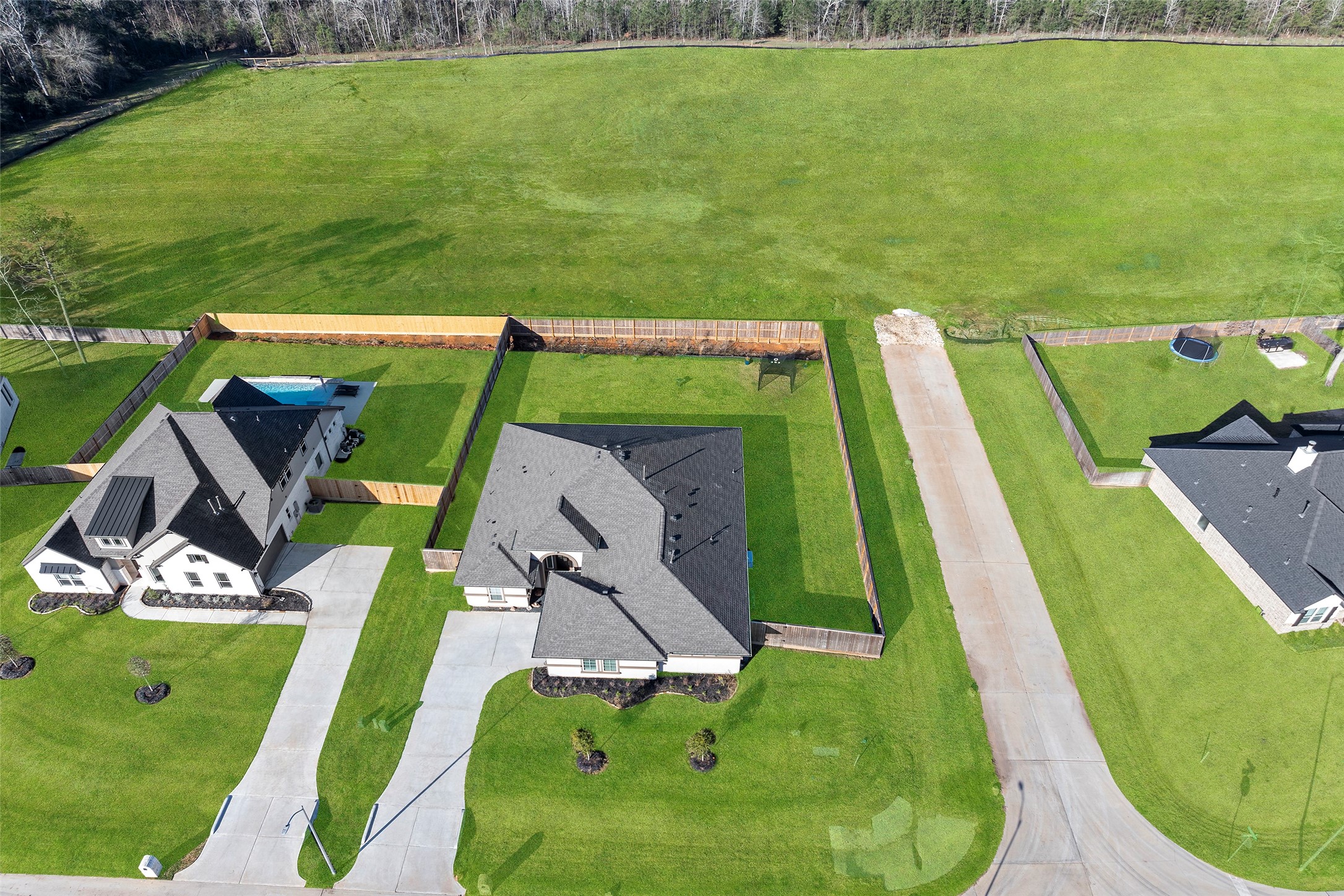 41015 Kimber Lane Magnolia, TX 77354 - Photo 4 of 44 a view of a swimming pool with a garden