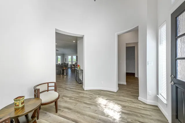 a hallway with a dining table and chairs
