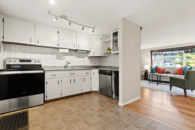 a kitchen with a stove sink and cabinets