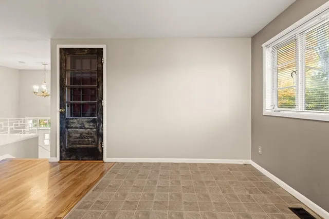 an empty room with closet and windows