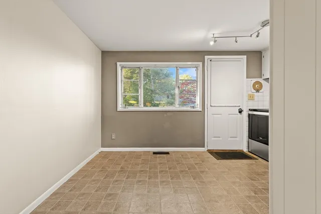 an empty room with windows and closet