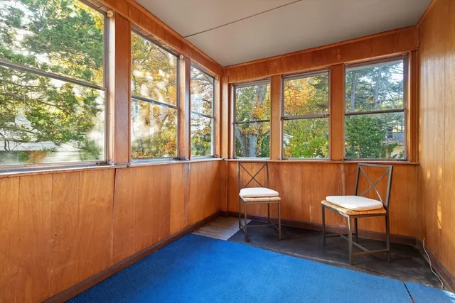 a room with pool table and a window