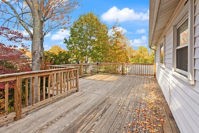 a view of balcony with wooden floor and fence