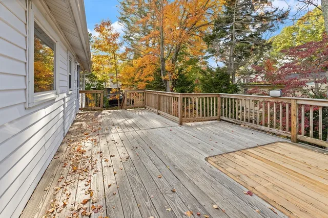 a view of balcony with wooden floor and fence