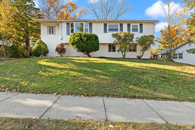 a view of a house with backyard and sitting area