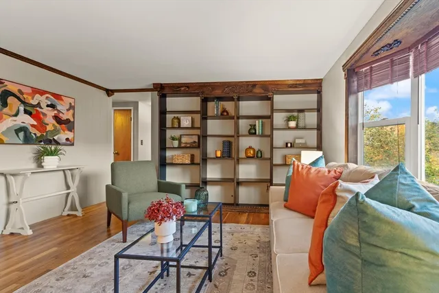 a living room with furniture a rug and a large window