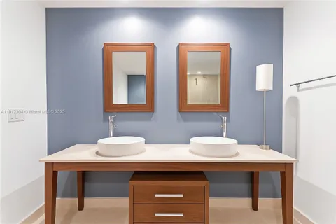 a bathroom with two sink and a mirror
