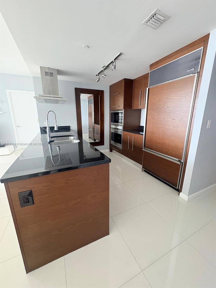 495 Brickell Avenue, Unit 5104 Miami, FL 33131 - Photo 7 of 21 a kitchen with stainless steel appliances granite countertop a refrigerator and a stove