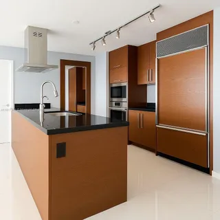 a kitchen with stainless steel appliances granite countertop a refrigerator and a sink