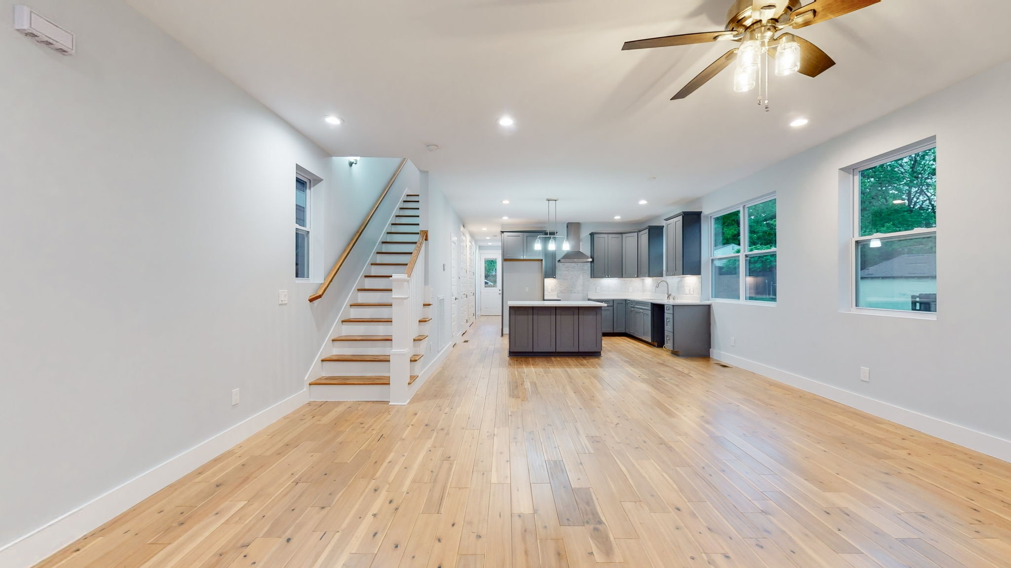 128 Ben Allen Road Nashville, TN 37207 - Photo 3 of 51 a view of an empty room with wooden floor and stairs