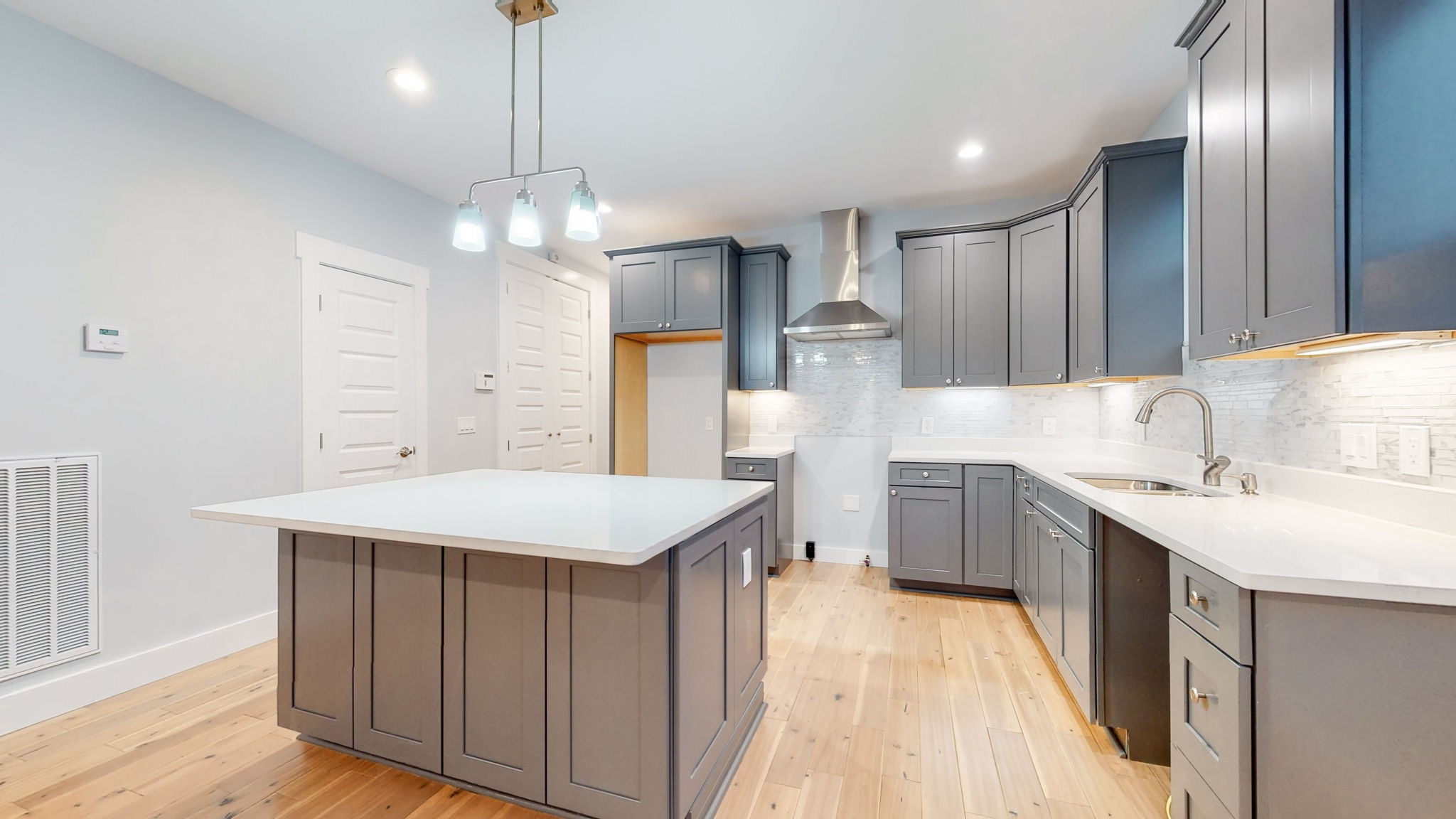 128 Ben Allen Road Nashville, TN 37207 - Photo 9 of 51 a kitchen with kitchen island granite countertop a sink stove and refrigerator