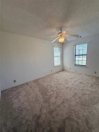 a view of an empty room with a fan