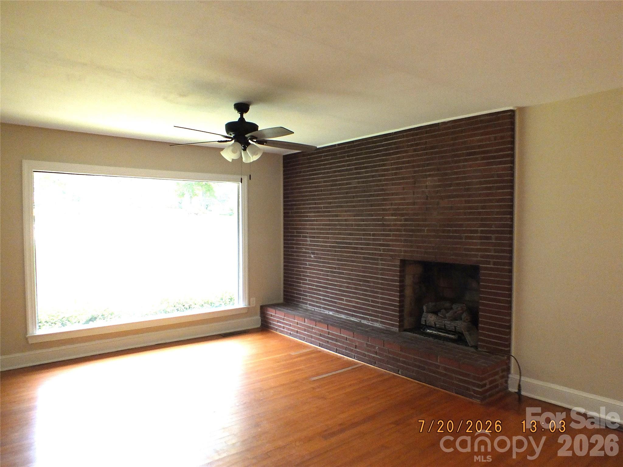 414 West Springs Street Lancaster, SC 29720 - Photo 6 of 22 an empty room with windows and fireplace