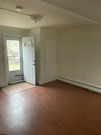 a view of a house with a door and a tree