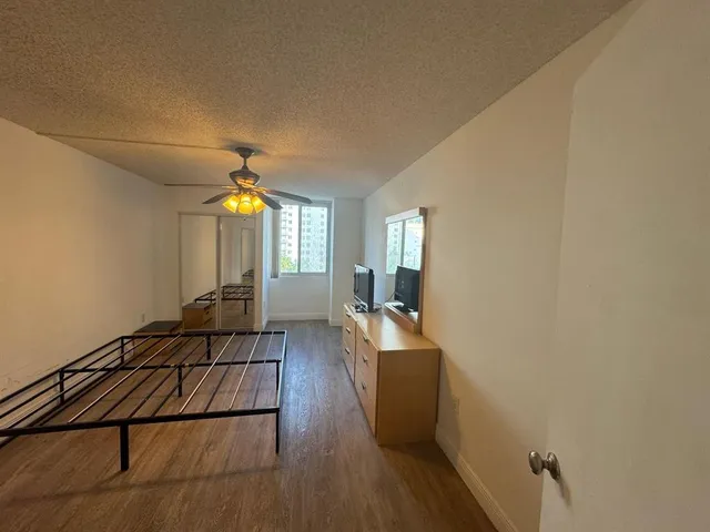 a view of a livingroom with wooden floor and staircase