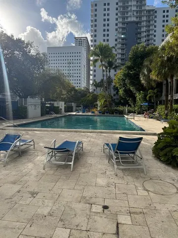 an outdoor sitting area with couch and outdoor seating