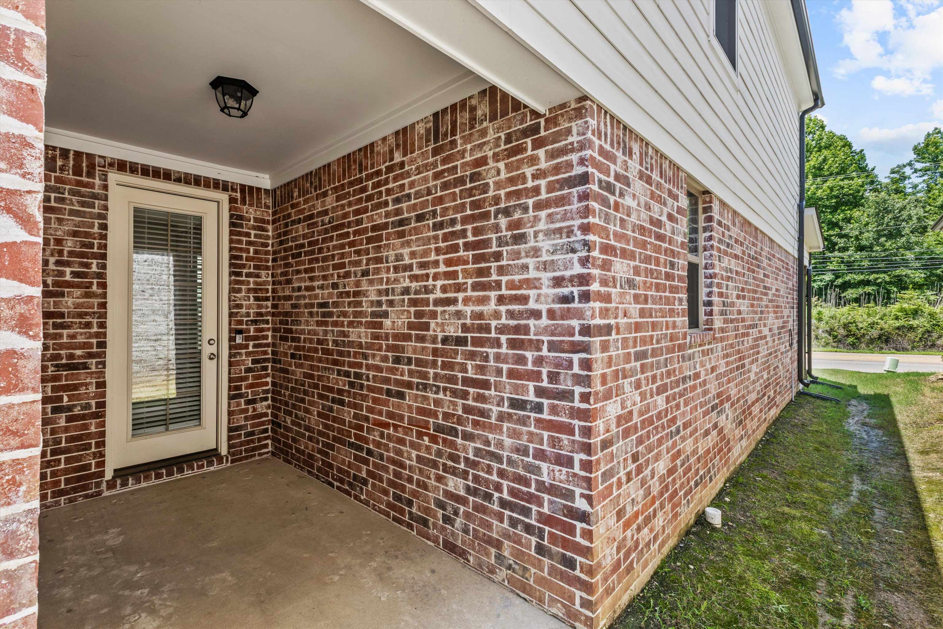 10139 Macon Road Cordova, TN 38018 - Photo 27 of 31 Brick exterior with white siding and a covered concrete patio