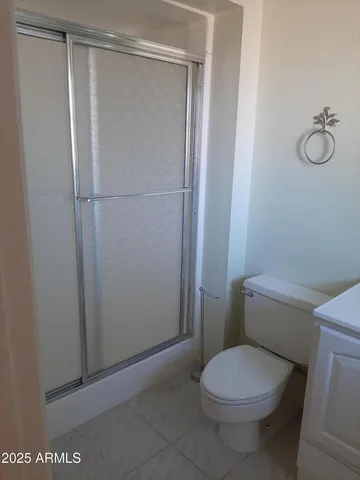a white toilet sitting next to a shower