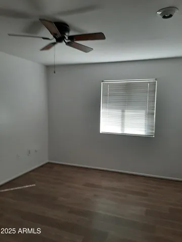 a view of a small space with wooden floor and a window