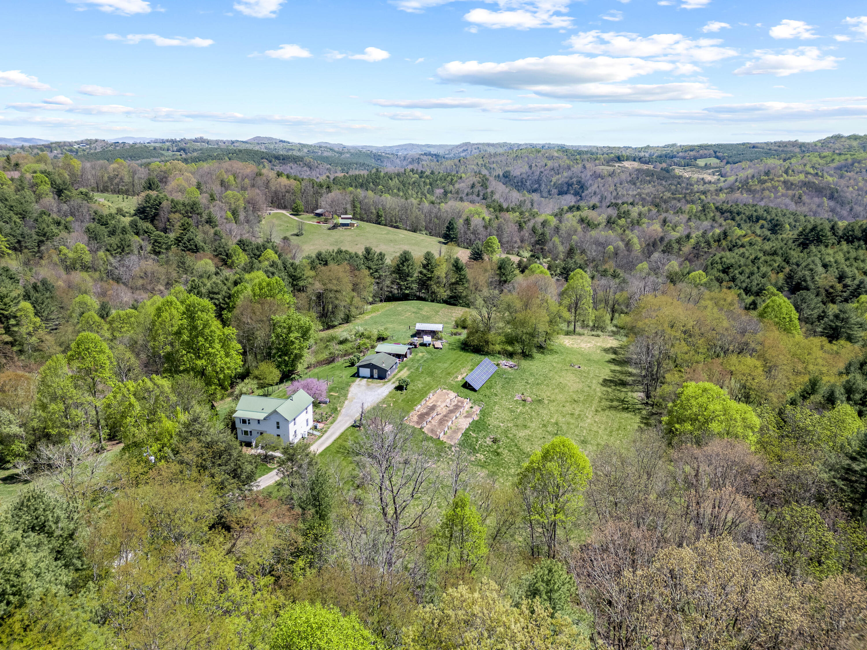 771 White Oak Grove Road Northeast Riner, VA 24149 - Photo 1 of 113 a view of a city with lush green forest