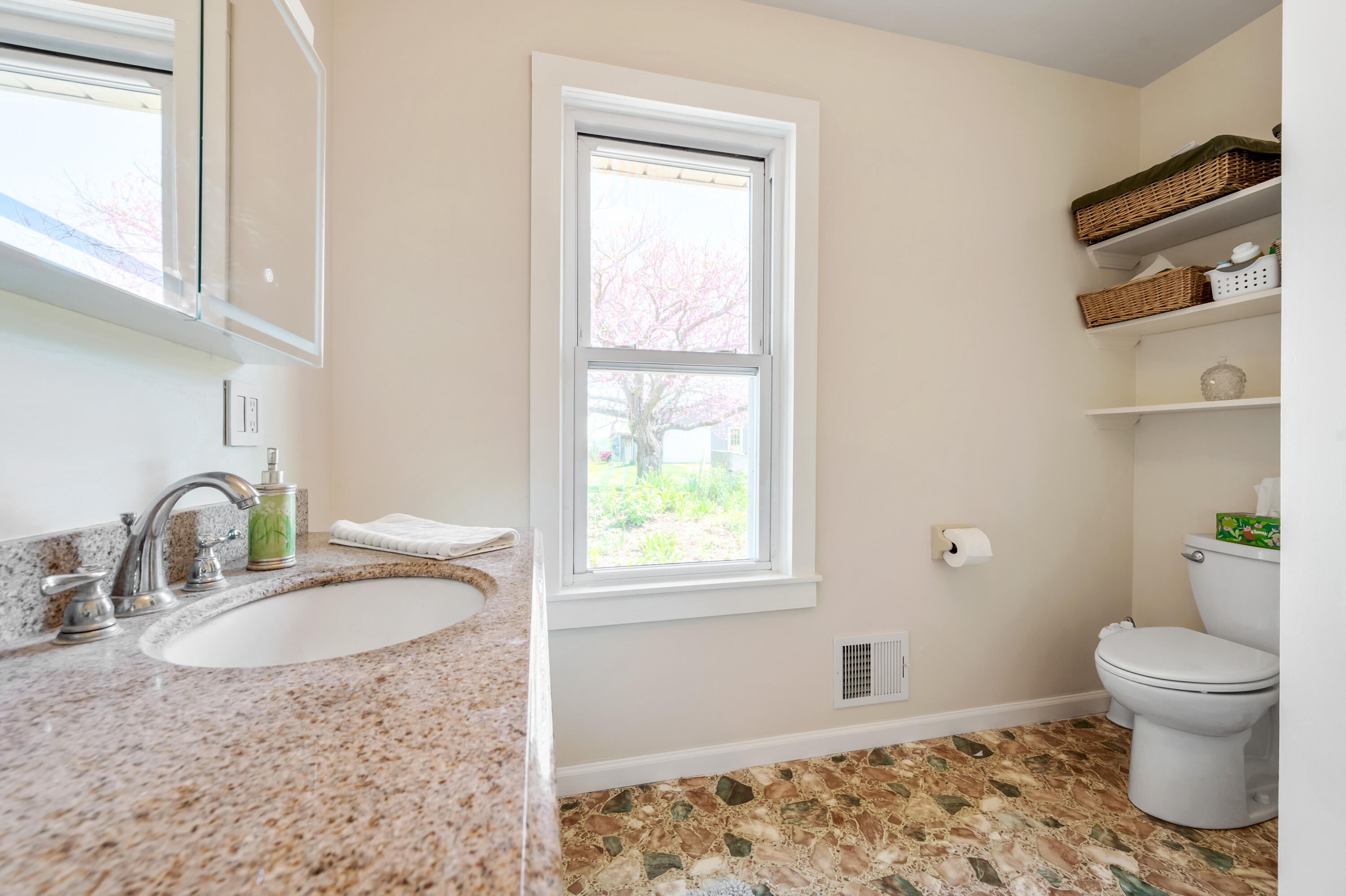 771 White Oak Grove Road Northeast Riner, VA 24149 - Photo 34 of 113 a bathroom with a granite countertop sink a toilet and a window