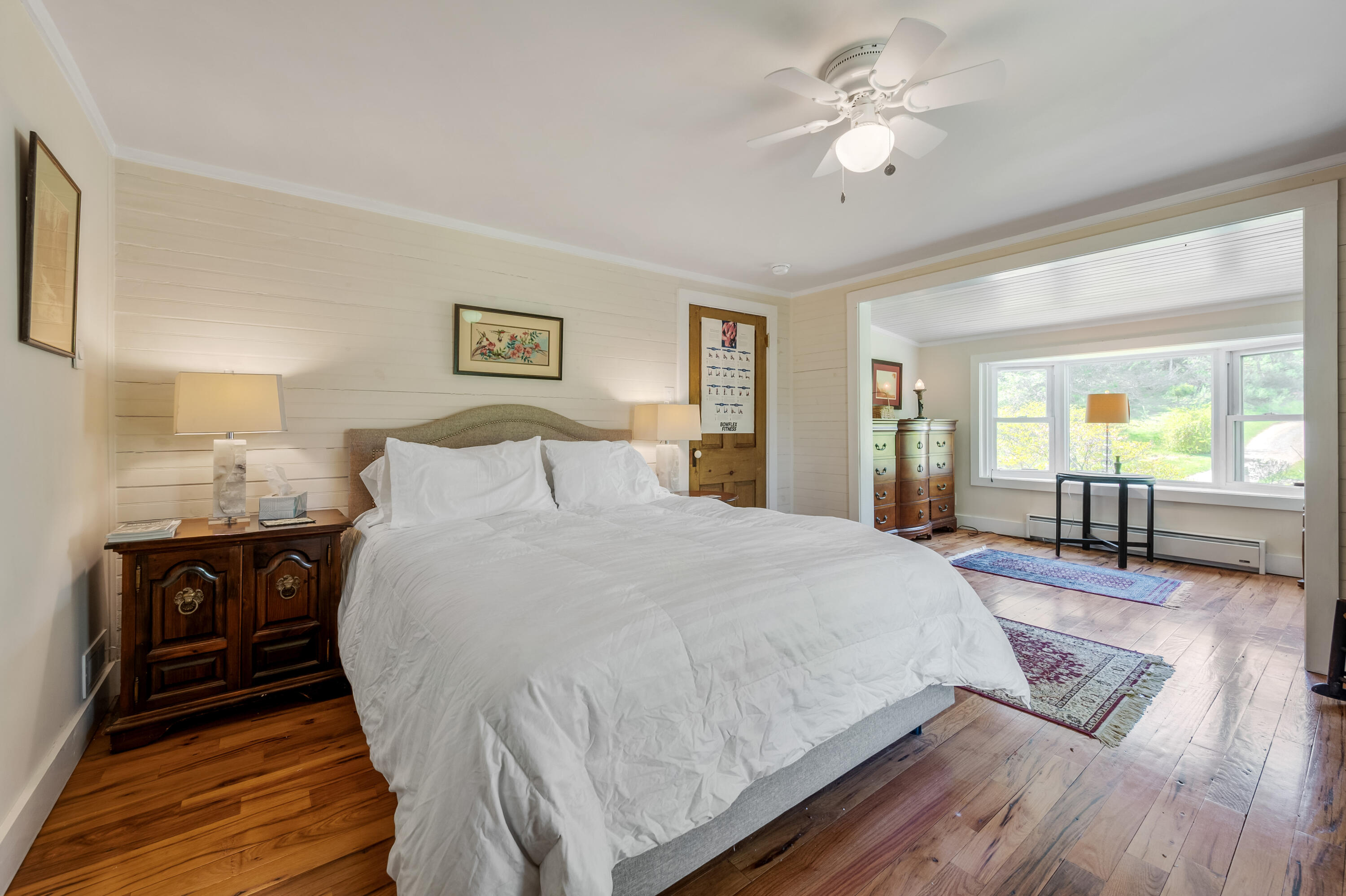 771 White Oak Grove Road Northeast Riner, VA 24149 - Photo 43 of 113 a spacious bedroom with a bed and dresser with wooden floor