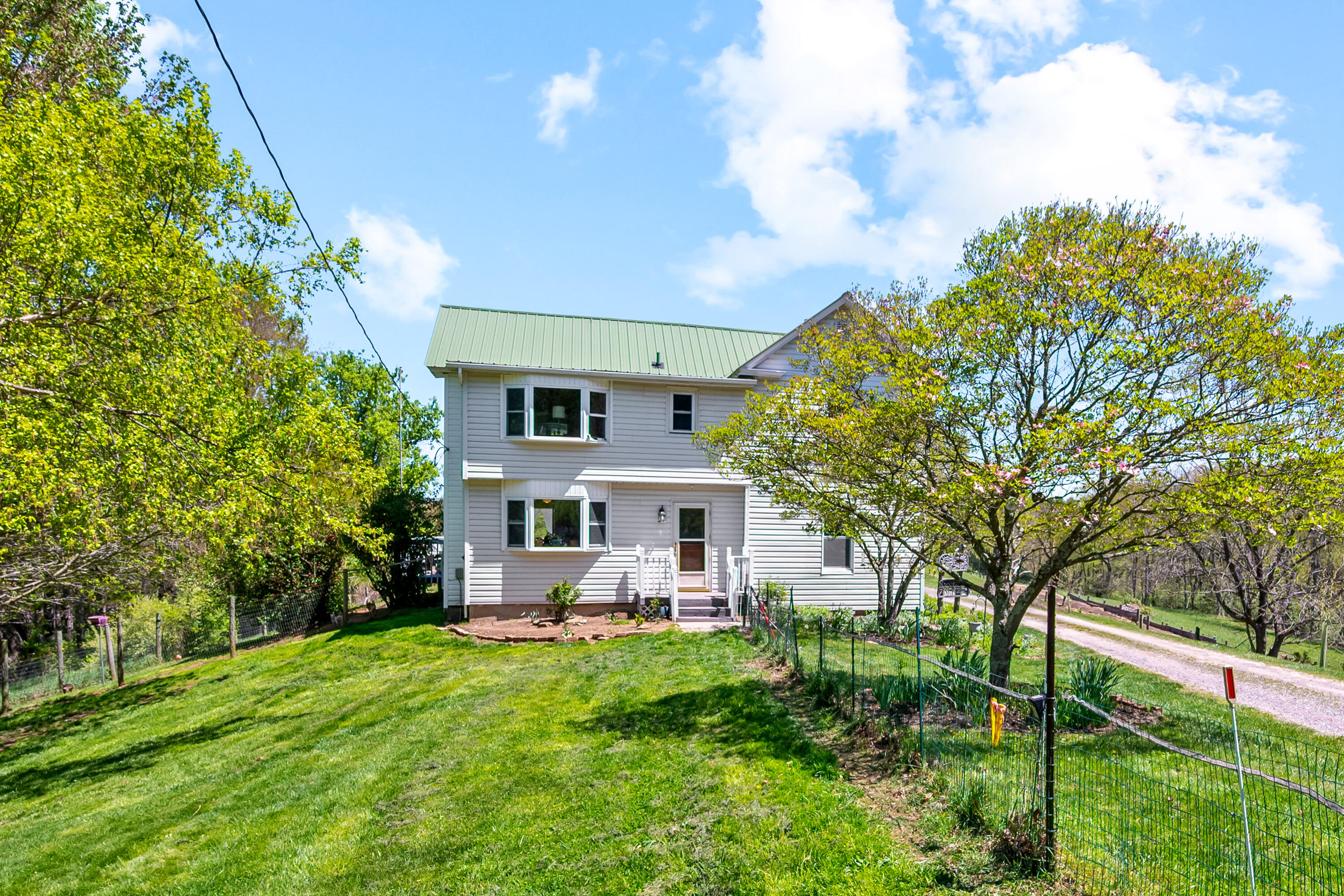771 White Oak Grove Road Northeast Riner, VA 24149 - Photo 5 of 113 a view of a house with a big yard potted plants and large tree