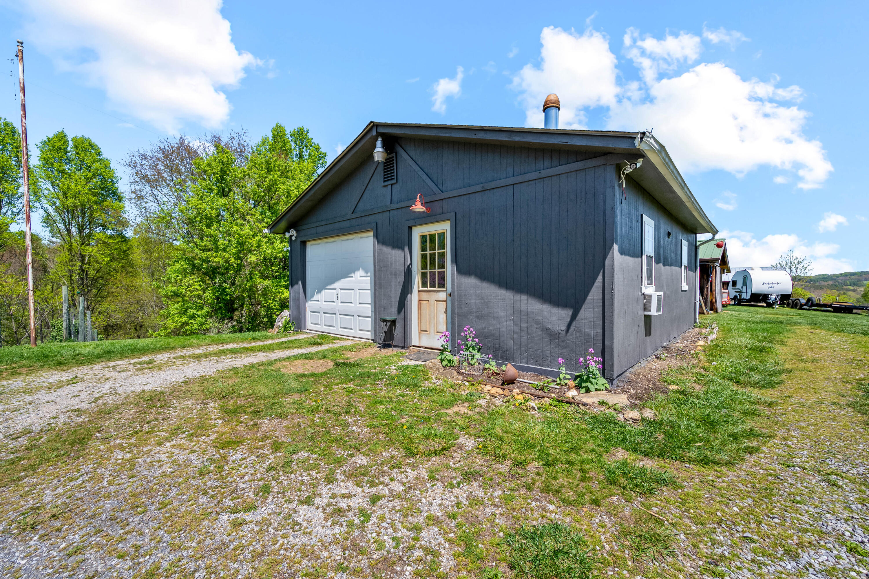 771 White Oak Grove Road Northeast Riner, VA 24149 - Photo 57 of 113 a backyard of a house with plants and large tree