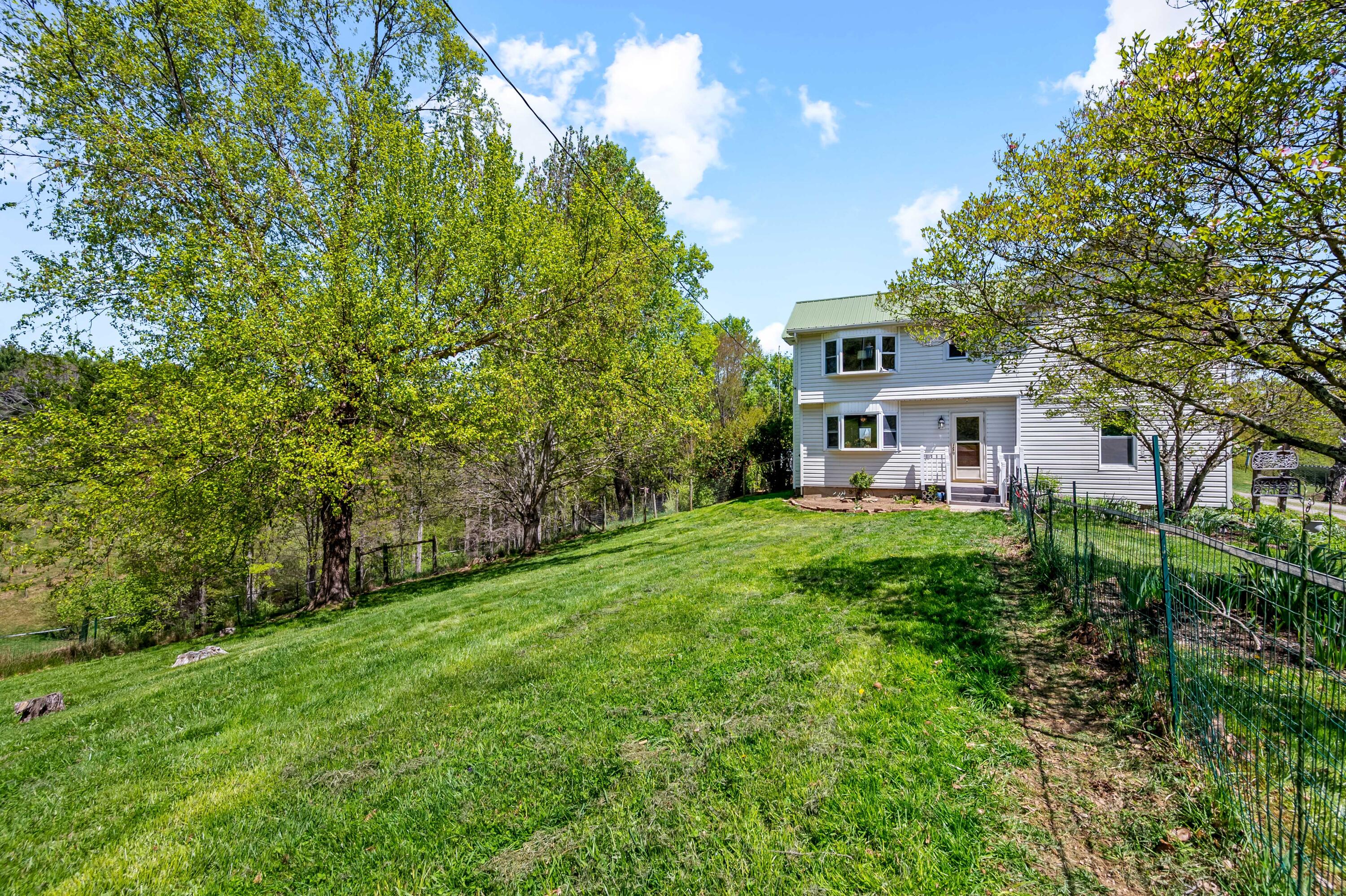 771 White Oak Grove Road Northeast Riner, VA 24149 - Photo 6 of 113 a view of a house with backyard and a sitting area