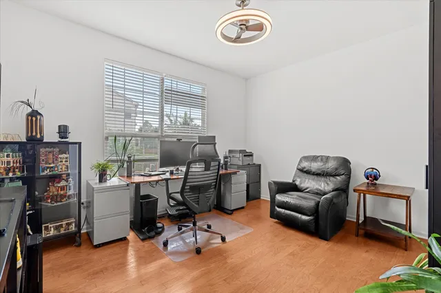 a view of a workspace with furniture and a window