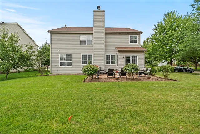 a front view of a house with garden and patio
