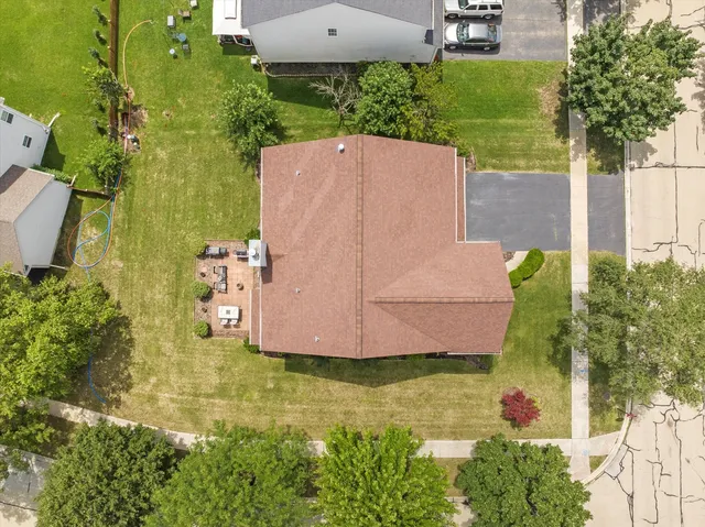 an aerial view of a house with a yard basket ball court and outdoor seating