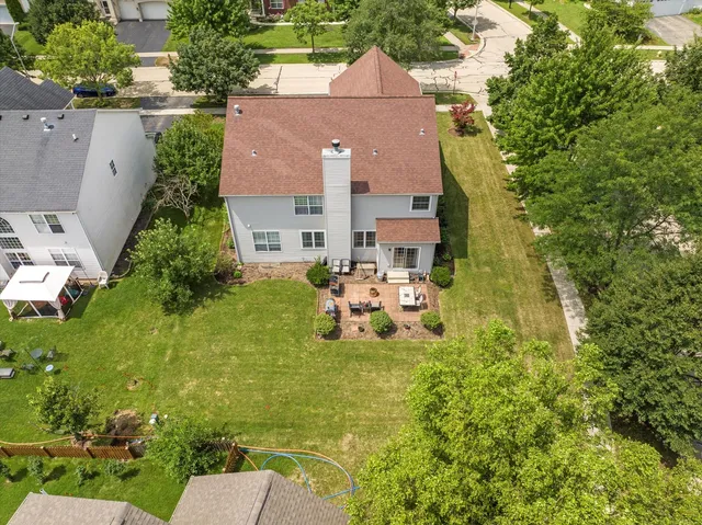 an aerial view of a house with swimming pool and garden