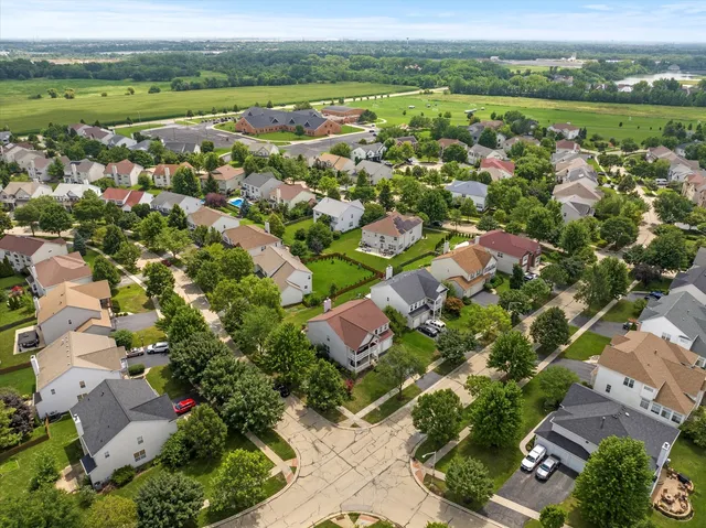 an aerial view of city lake and residential houses with outdoor space