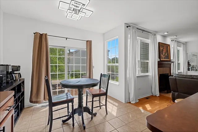a dining room with furniture and a window