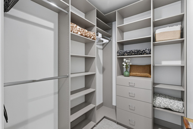 12308 Mariah Circle Draper, UT 84020 - Photo 211 of 293 Guest House Custom closet system featuring multiple hanging rods, adjustable shelving, and integrated drawer storage