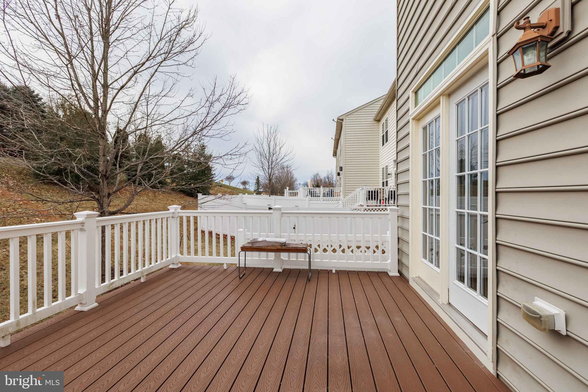 9733 Braidwood Terrace Frederick, MD 21704 - Photo 24 of 33 a view of a balcony with wooden floor and fence