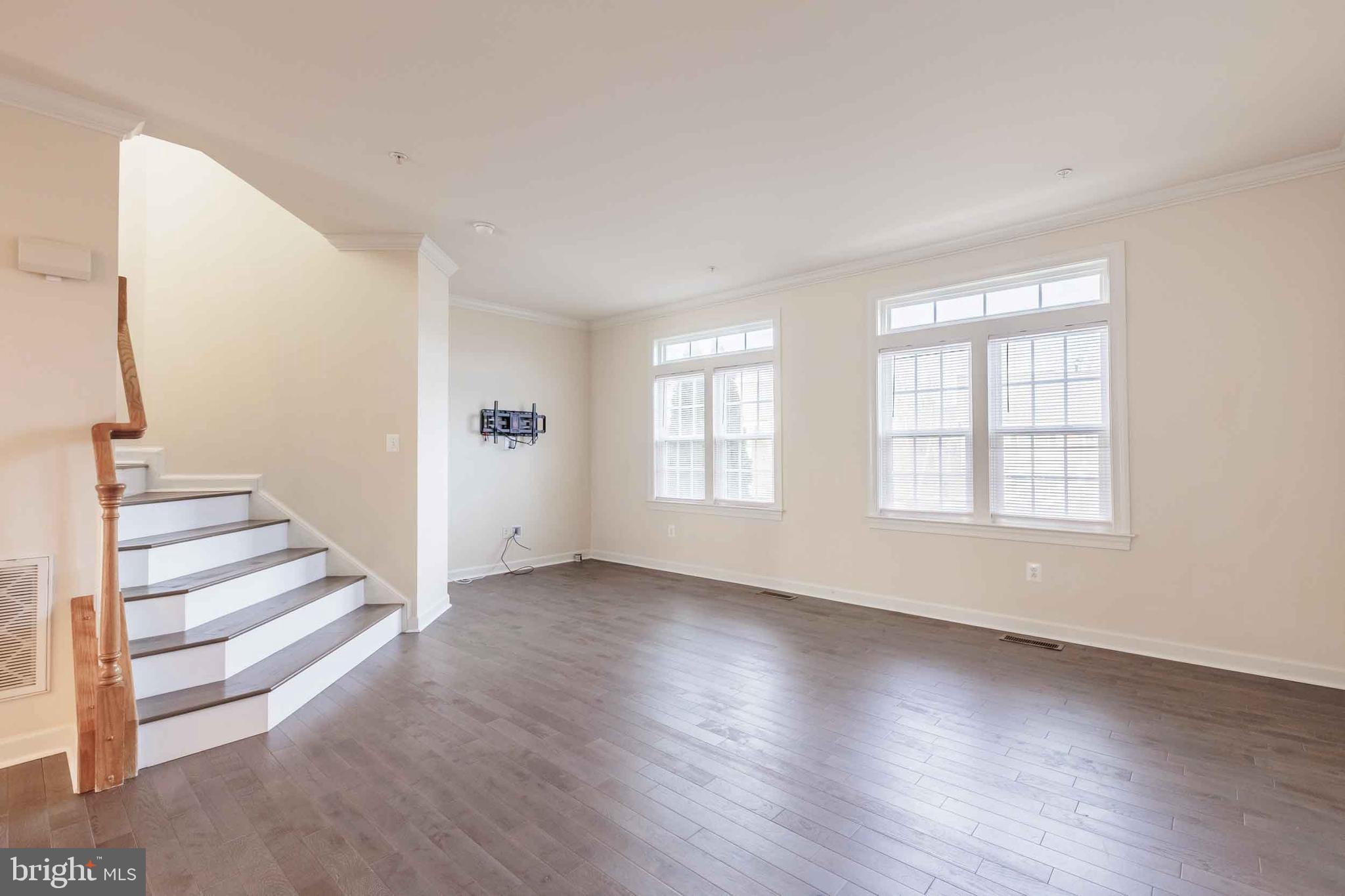 9733 Braidwood Terrace Frederick, MD 21704 - Photo 10 of 33 wooden floor in an empty room with a window