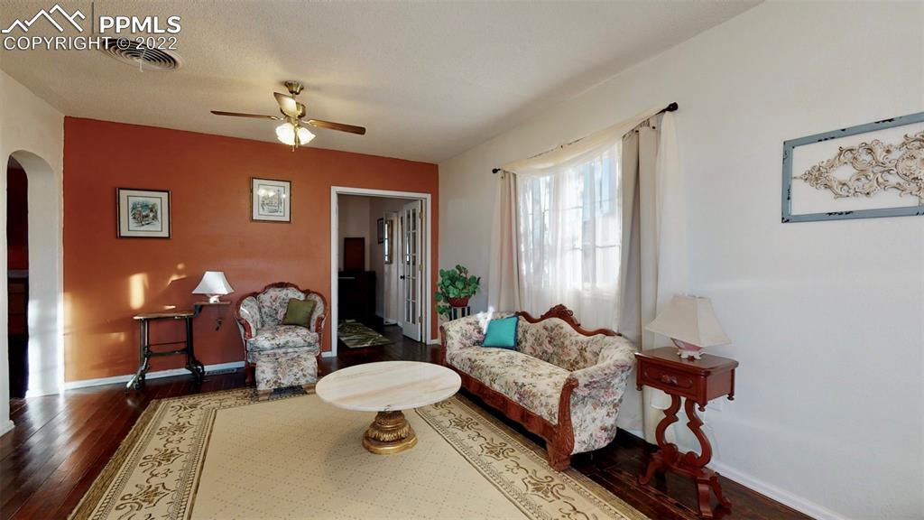 211 West 3rd Street Walsenburg, CO 81089 - Photo 6 of 33 a living room with furniture a chandelier and a rug