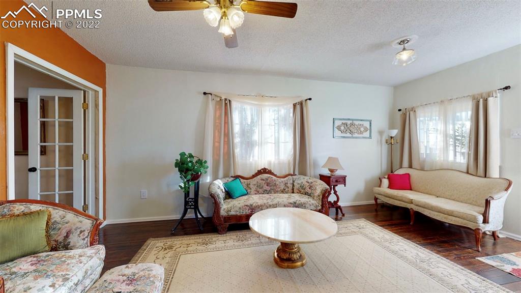211 West 3rd Street Walsenburg, CO 81089 - Photo 8 of 33 a living room with furniture and a chandelier