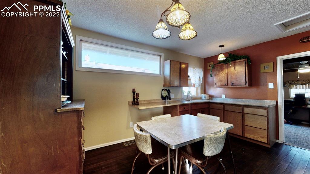 211 West 3rd Street Walsenburg, CO 81089 - Photo 10 of 33 a kitchen with a table and chairs in it