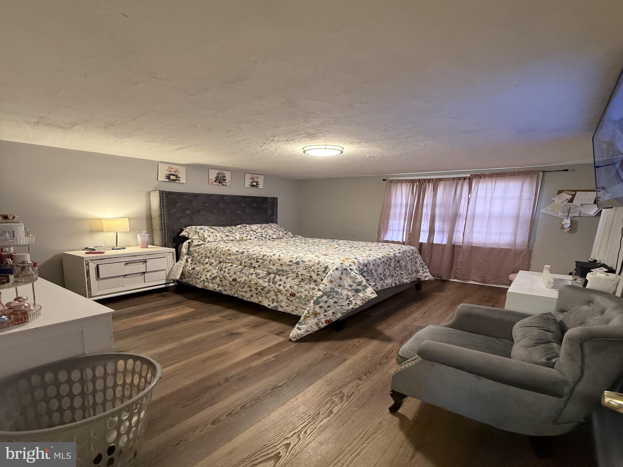 229 West 22nd Street Chester, PA 19013 - Photo 12 of 18 a bedroom with a bed couch and window